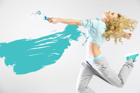 Fit lady painting empty wallsの写真素材