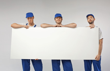 Portrait of handsome young workersの写真素材