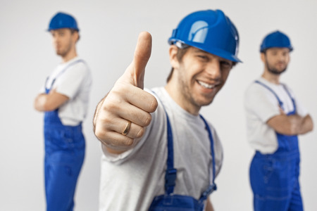 Portrait of three optimistic workersの写真素材