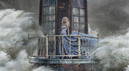 Conceptual photo of a lady standing on the lighthouseの写真素材