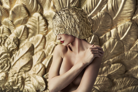 Conceptual portrait of a seductive woman wearing feather hatの写真素材