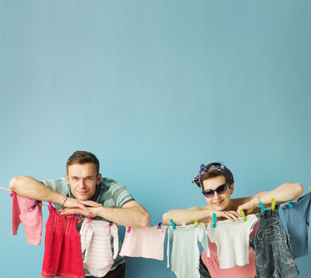 Happy attractive parents doing the laundryの写真素材