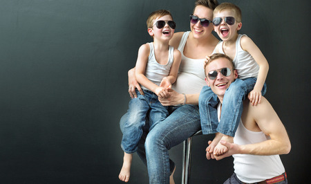 Glad family on black studio backgroundの写真素材