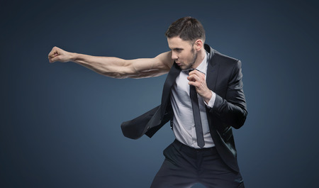 Portrait of a fighting muscular businessmanの写真素材
