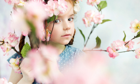 Little girl holding a colorful branchの写真素材