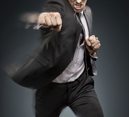 Handsome businessman dfeating an another challangerの写真素材