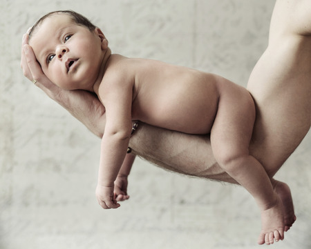 Father holding a cute newborn childの写真素材