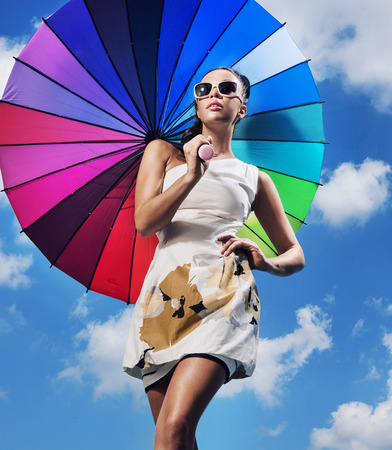 Pretty young lady holding an umbrellaの写真素材