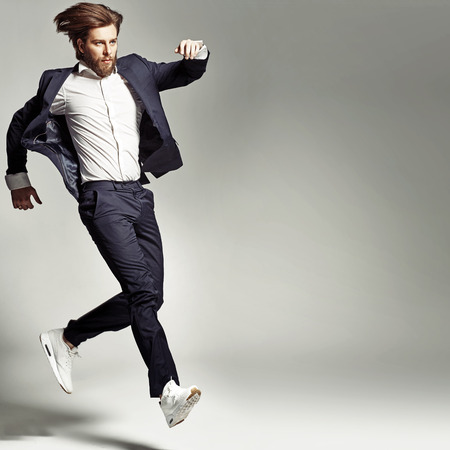 Young energetic guy wearing suitの写真素材