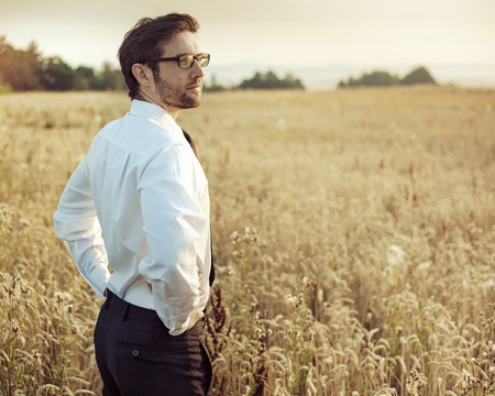 Handsome young owner looking at his landの写真素材