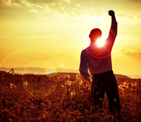 Cheerful businessman looking at the sunsetの写真素材