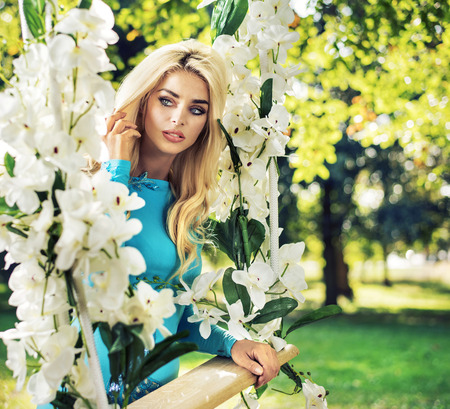 Amazing blond nymph swings on the ornate seesawの写真素材