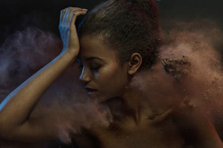 Portrait of a sensual lady among dark sandの写真素材