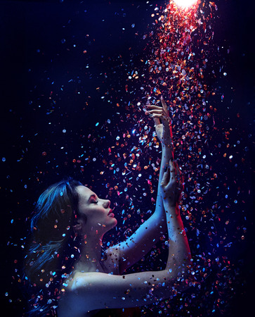 Portrait of a brunette lady taking a sequin showerの写真素材