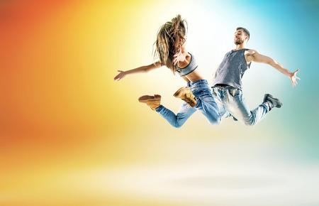Two talented dancers practising in large studio