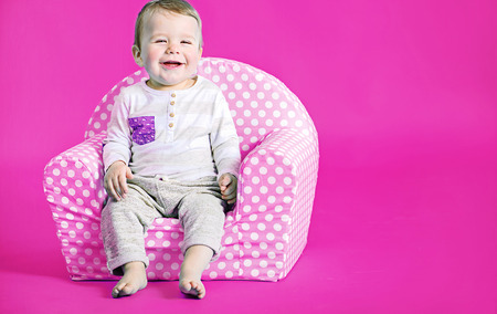 Little cute boy in the pink area