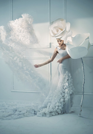 Elegant young woman in a white roomの写真素材