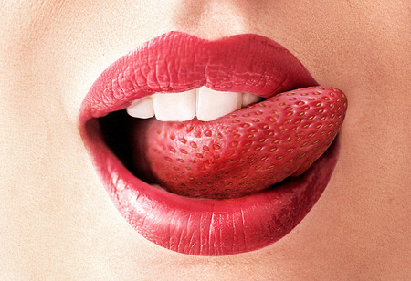 Closeup image of a red strawberry tongueの写真素材