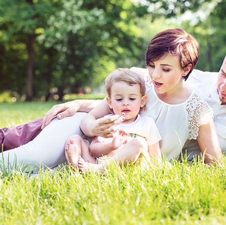 Chherful family resting in the city parkの写真素材