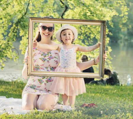 Pretty mother posing with her beloced daughterの写真素材