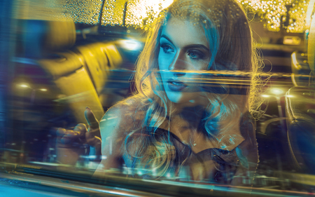 Attractive blond lady driving an elegant vehicleの写真素材