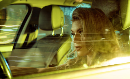 Attractive young lady sitting behind the wheel