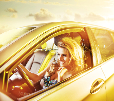 Portrait of a blond young woman driving a limoの写真素材