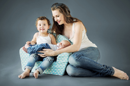 Atrractive mom takes care of her childrenの写真素材