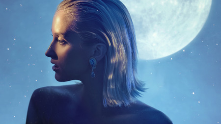 Pretty blond woman with golden dust on the skinの写真素材