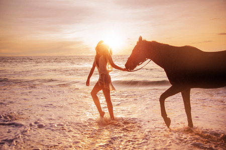 Portrait of an alluring woman with a majestic horseの写真素材