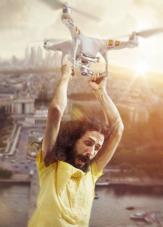 Portrait of a funny man flying with a drone