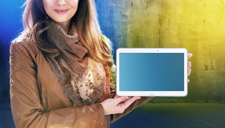 Attractive young woman holding a tabletの写真素材