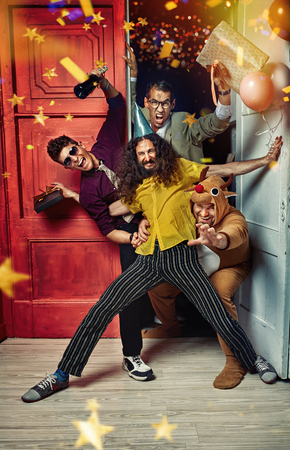 Portrait of funny, handsome guys on the partyの写真素材