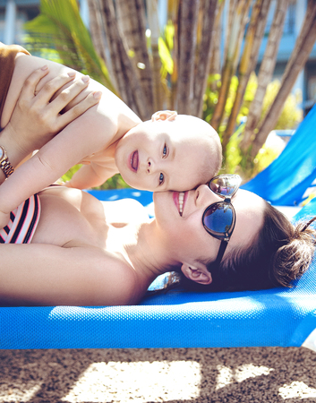 Attractive young mother hugging her beloved sonの写真素材