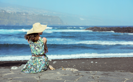 Young, pretty woman relaxing by the seasideの写真素材