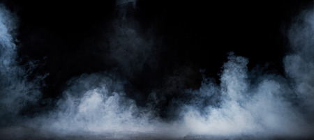 Image of dense smoke swirling in the dark interiorの写真素材