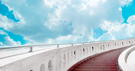Stairs towards brifht blue sky with clouds