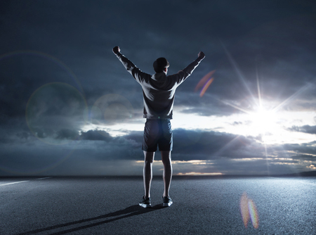 Fit man looking at the dark skyの写真素材