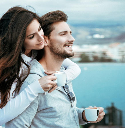 Portrait of a relaxed, young couple drinking hot coffeeの写真素材