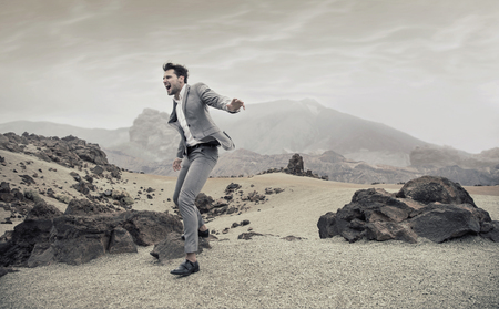 Portrait of a screaming young businessman on a desertの写真素材