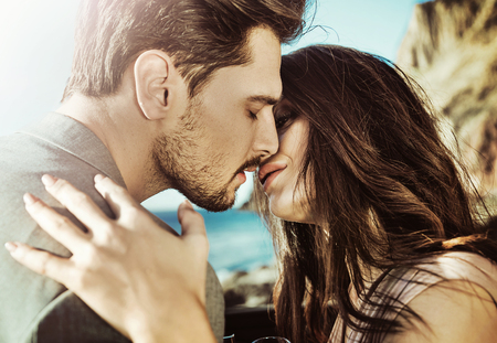Portrait of a young, kissing coupleの写真素材