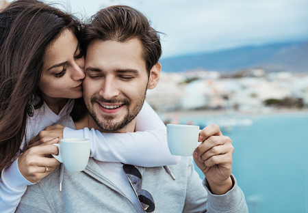 Romantic, relaxed couple drinking a mornig cup of coffeeの写真素材