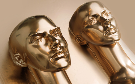 Two heads of human golden scuplturesの写真素材