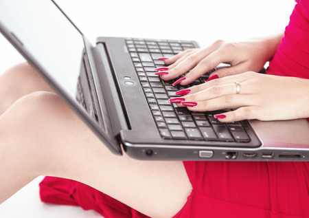 Elegant, young woman using a laptop - isolatedの写真素材