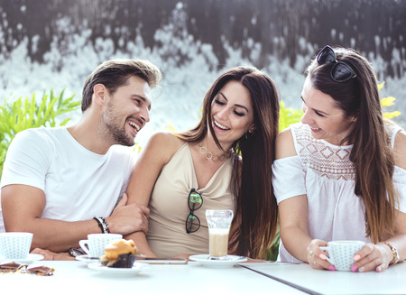 Group of cheerful friends in the coffee houseの写真素材