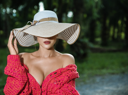 Sensual blond woman wearing a straw hatの写真素材