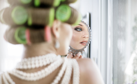 Portrait of an elegant woman preparing for a partyの写真素材