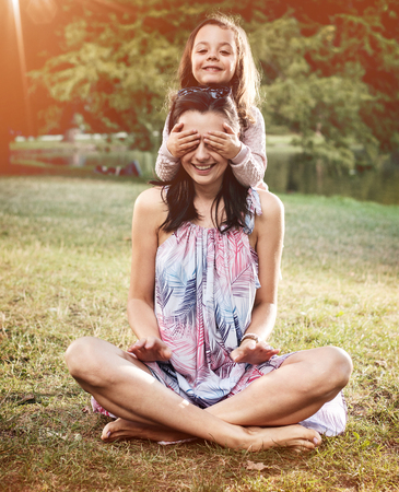 Mother and daughter having a great fun in the summer parkの写真素材