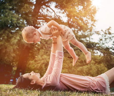 Mother and son having a great fun in the summer parkの写真素材