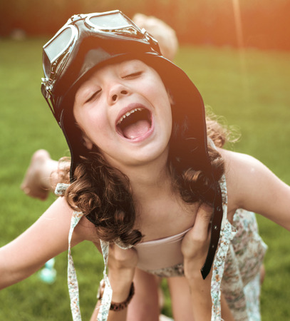 Portrait of a little flying pilot-child having funの写真素材